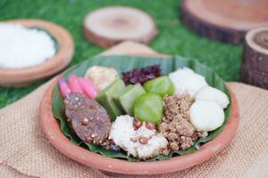 Jenang Madura is a typical Indonesian food that consists of black sticky rice, porridge marrow, jenang grendul and red pearls that were given palm sugar and coconut milk photo