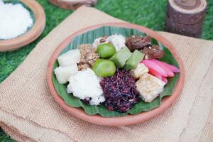 Jenang Madura is a typical Indonesian food that consists of black sticky rice, porridge marrow, jenang grendul and red pearls that were given palm sugar and coconut milk photo