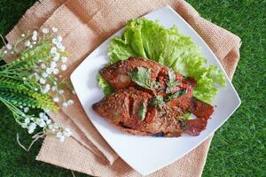 Fried mackerel fish with chili sauce photo