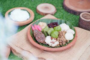 Jenang Madura is a typical Indonesian food that consists of black sticky rice, porridge marrow, jenang grendul and red pearls that were given palm sugar and coconut milk photo