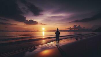 A serene beach scene during sunset with the silhouette of a lone individual by the shoreline, reflecting on the water against a backdrop of vibrant hues. AI Generated photo