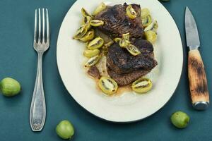 Grilled ostrich steak with kiwi sauce photo
