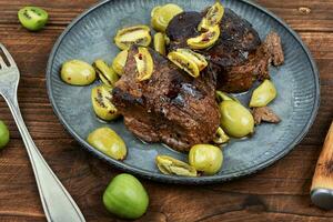 Fried ostrich steak with kiwi sauce photo