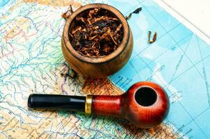 Tobacco pipe on the map photo