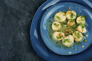 Scallops seared in garlic, space for text. photo