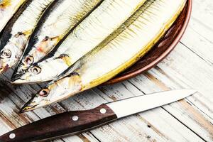 Hot smoked fish on plate photo