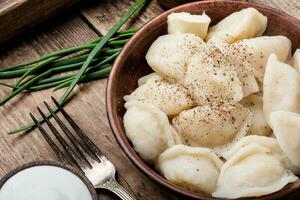 Dumplings with potatoes in plate photo