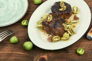 Fried ostrich steak with kiwi sauce photo