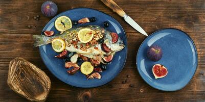 Baked sea bream dorada fish with figs. photo