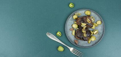 Grilled ostrich steak with kiwi berries photo