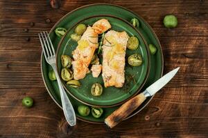 Baked salmon steaks with mini kiwi. photo