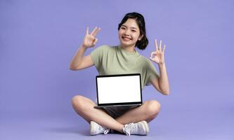 retrato de hermosa asiático mujer posando en púrpura antecedentes foto