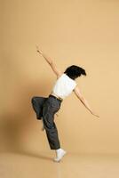 Image of Asian dancer dancing on beige background photo