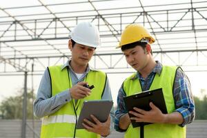 Engineers team use tablet and check the blueprint on site. Contractor and inspector inspection construction during project.civil Forman check quality assurance. Audit, inspect, quality control. photo