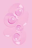 a pink background with many bubbles on it photo