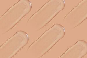 transparent cosmetic gel smeared on a beige background photo