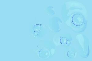 drops of transparent gel with air bubbles on a blue background photo