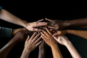 Group of diverse people putting hands together on black background, closeup, Team members high-fiving close-up, Hands visible only, No visible faces, No hand deformities, AI Generated photo