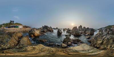 full hdri 360 panorama view on ocean on shore with rocks in equirectangular projection with zenith and nadir. VR AR content photo