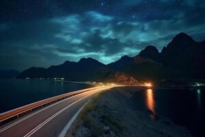 Highway in the mountains at night with starry sky background. photo