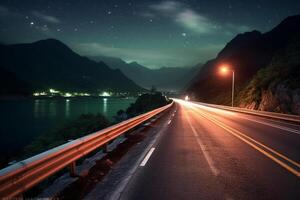 Highway in the mountains at night with starry sky background. photo