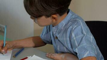 Cute little boy smiling to the camera while drawing video