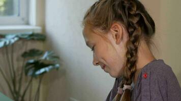 Adorable red haired girl with freckles smiling and drawing at school video