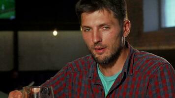 Mature man smiling to the camera while drinking beer video