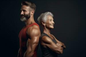 Athletic elderly muscular man and woman in gym before workout photo
