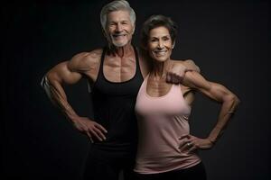 Athletic elderly muscular man and woman in gym before workout photo