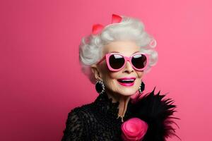 Fashionable elderly woman isolated on pink photo