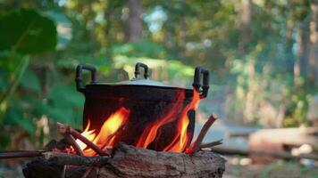 Light a fire to cook rice using firewood as fuel. video