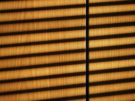 blinds shadow on wooden wall background photo