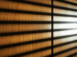 blinds shadow on wooden wall background photo