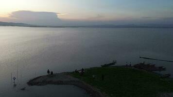 aerial view of people enjoying a picnic on the shore of Limboto Lake, Gorontalo video