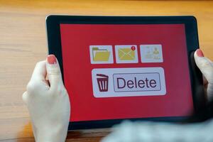 Deleting documents, junk mail, electronic messages or personal information in tablet system. Concepts of technology and document management from online platforms photo