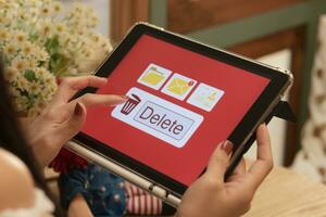 Deleting documents, junk mail, electronic messages or personal information in tablet system. Concepts of technology and document management from online platforms photo