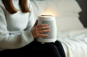 Woman warming hands near heater. Generate Ai photo