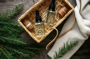 Bottles with essential pine oil with branches in wicker box. Generate ai photo