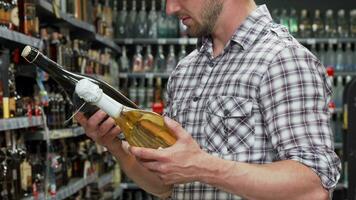 Man choosing between two bottles of wine video