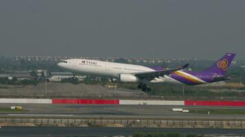 BANGKOK, THAILAND MARCH 01, 2023 - Airplane of THAI landing and touching at Suvarnabhumi Airport, side view. Aircraft arriving. video