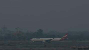 BANGKOK, THAILAND MARCH 01, 2023 - Passenger Boeing of QANTAS Airlines accelerating for takeoff at Suvarnabhum airport, Bangkok video