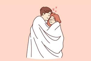 Romantic man and woman wrapped in white blanket embrace and feel love and passion photo