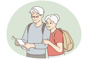 Smiling mature couple look at map traveling photo