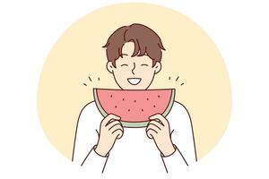 Smiling man eating watermelon photo