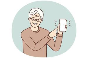 Smiling elderly man point at cell screen photo