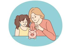 Mother and daughter put coin in piggybank photo