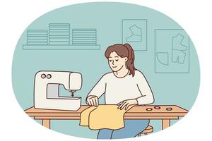 Female seamstress sewing on machine photo