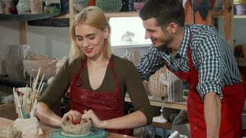 Young couple enjoying working with clay at the pottery workshop video