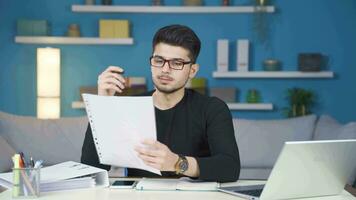 Young man working in home office reading bad news and getting upset. video